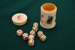 A bone box with dice.