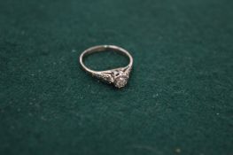 An 18ct gold and diamond single stone ring, size L½.