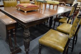 Victorian walnut extending dining table with two leaves.