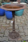 A small cast iron bird bath.