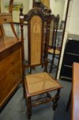 A pair of oak and cane work high back dining/occasional chairs.