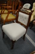 A Victorian oak framed and upholstered side chair.