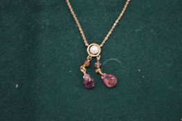 An Edwardian gold, pearl and tourmaline pendant with chain.