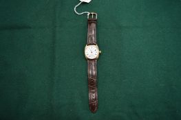 A Waltham 9ct gold gents wristwatch with leather strap.