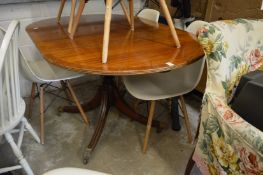 A mahogany drop-leaf dining table.