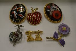 Five decorative brooches and a pair of teddy bear cufflinks.