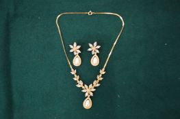 A diamante pendant and earrings.