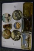 A collection of souvenir glass paperweights.