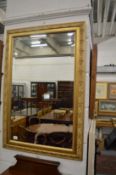 A gilt framed mirror.