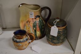 A large Doulton jug decorated with Dickensian characters together with a Doulton Lambeth tobacco jar