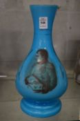 A blue glass vase decorated with Napoleon.