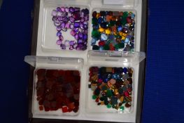 Four boxes of coloured stones.