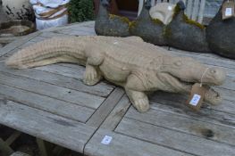 A reconstituted stone ornament modelled as a crocodile.