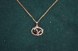 A 9ct gold chain with garnet set pendant.