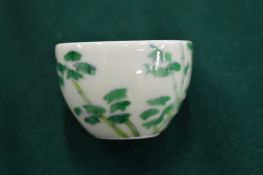 A small Chinese porcelain cup decorated with bamboo.
