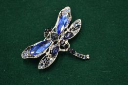 A decorative dragonfly brooch.