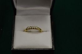 A 9ct gold and diamond five stone ring, size L.