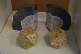 A pair of crystal book ends and two obelisks.