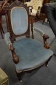A Victorian carved walnut framed open armchair.