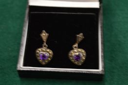 A pair of decorative silver earrings.