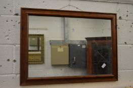 A stained pine framed mirror.