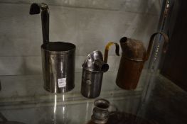 A steel measure, two non spill milk pourers and a small tankard.