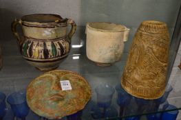 A pottery mask, a pottery twin handled jar and two other items.