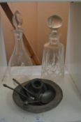 Pewter items and two cut glass decanters.