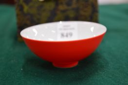 A small Chinese red glazed porcelain bowl, boxed.