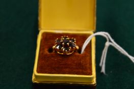 A 9ct gold and garnet cluster ring, size M.