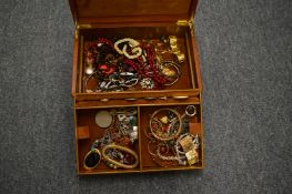 A jewellery box containing a large quantity of costume jewellery.