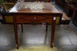 A small inlaid hardwood coffee table with reversable checker board inlaid top.
