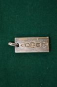 A silver ingot pendant.
