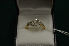 A gold and cubic zirconia ring, size S.