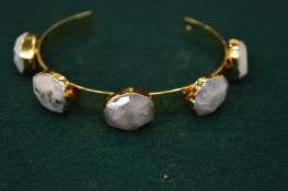 A bracelet set with five hard stones.