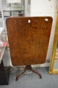A 19th century oak rectangular tilt-top tripod table.