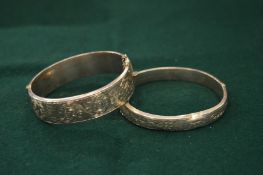 Two engraved silver bangles.