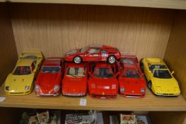 Six large die-cast Ferrari cars.