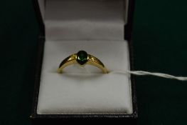 A 9ct gold and green stone ring, size U.