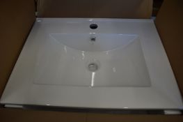 A porcelain sink, boxed and unused together with an extractor fan.