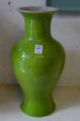 A pair of Chinese baluster shaped vases, one bright green the other bright blue.