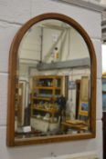An arched top mirror.