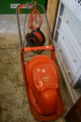 A Flymo Hover Vac 280 electric lawn mower and a cable reel.