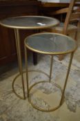 Two glass top circular metal tables.