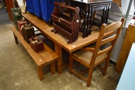 A heavy oak extending dining table with two armchairs, three single chairs and a bench seat.