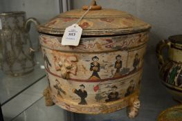 An unusual Chinese pottery lidded circular vessel supported on three molded legs.