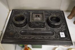 A carved ebony desk stand.