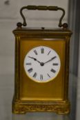 A good brass carriage clock with engraved case, the movement striking on a gong.