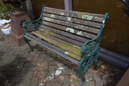 A cast metal and wooden slatted garden bench.