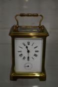 A brass carriage clock with alarm.
